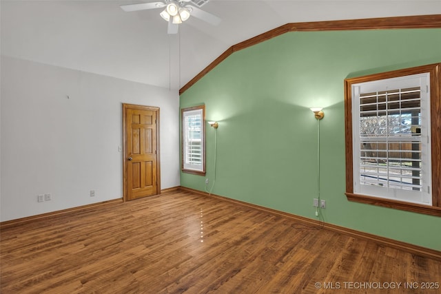 unfurnished room with lofted ceiling, ceiling fan, wood finished floors, and baseboards