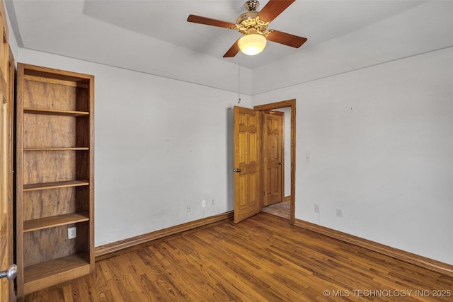 unfurnished bedroom featuring ceiling fan, baseboards, and wood finished floors