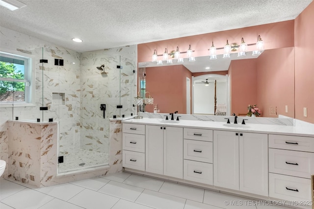 bathroom featuring ceiling fan, visible vents, a sink, and a marble finish shower