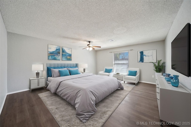 bedroom with ceiling fan, baseboards, a textured ceiling, and wood finished floors