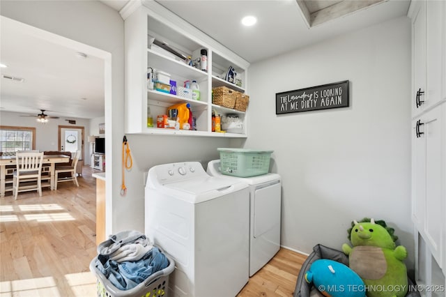 laundry room featuring laundry area, visible vents, ceiling fan, light wood-style floors, and washing machine and dryer