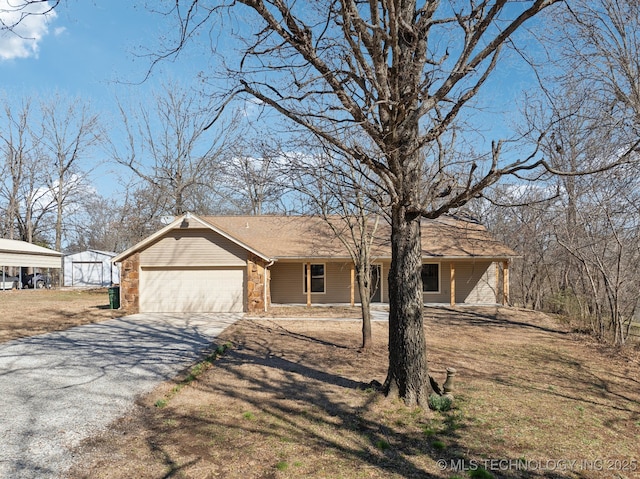 view of front of house featuring driveway, a porch, an attached garage, and a front yard