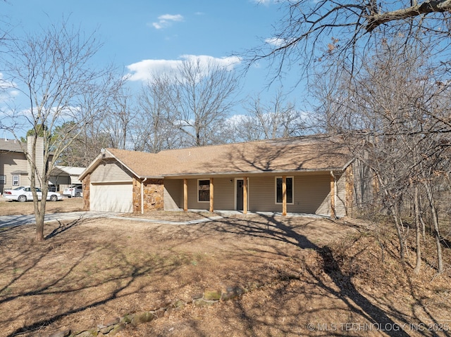 view of front of house featuring covered porch, driveway, and an attached garage