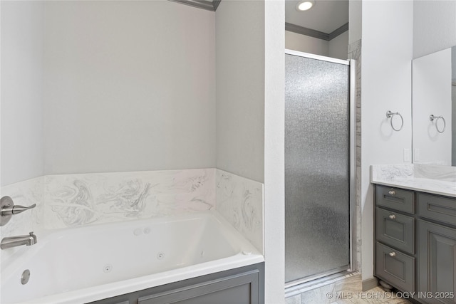 bathroom featuring a whirlpool tub, a shower stall, and vanity