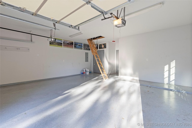 garage with a garage door opener and electric panel