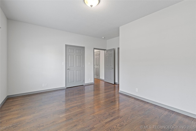 unfurnished bedroom featuring baseboards and wood finished floors