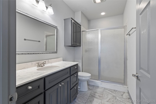 bathroom with toilet, marble finish floor, vanity, and a stall shower