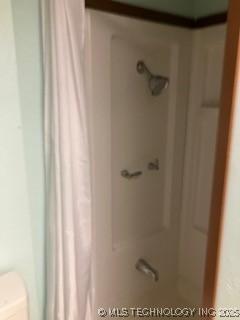 bathroom featuring a shower with curtain