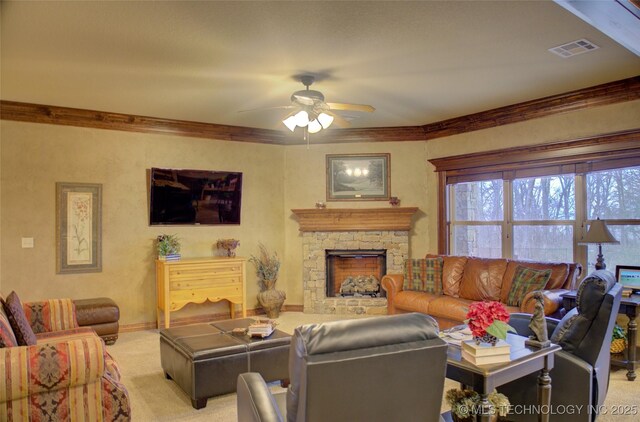 living room with light carpet, a fireplace, visible vents, a ceiling fan, and ornamental molding