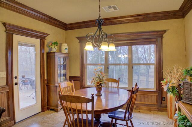 dining area featuring crown molding, visible vents, plenty of natural light, and an inviting chandelier