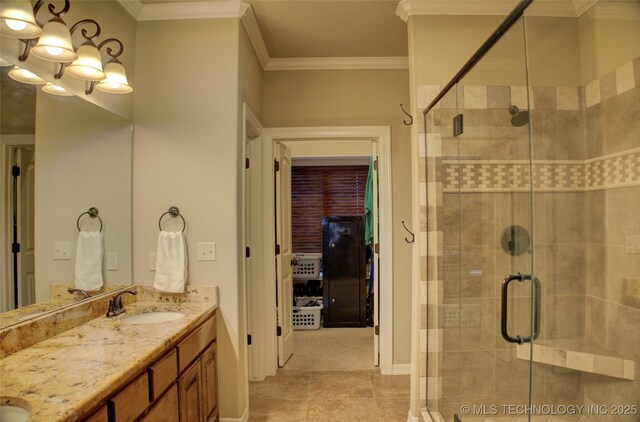 bathroom with double vanity, ornamental molding, a stall shower, and a sink