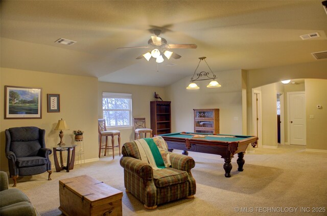 recreation room featuring arched walkways, lofted ceiling, visible vents, and light colored carpet