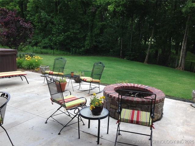 view of patio / terrace with an outdoor fire pit and fence