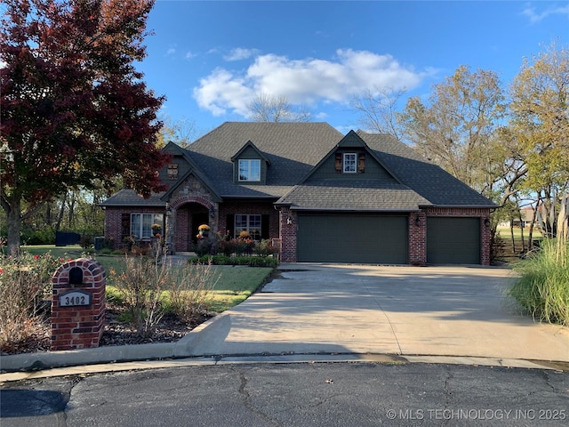 view of front of home with a shingled roof, brick siding, driveway, and an attached garage