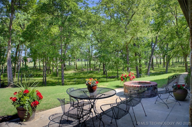 3402 Harbour Town Pl, Claremore, OK 74019 - fenced backyard with a patio area, a fire pit, and outdoor dining space