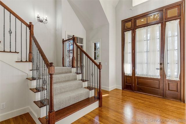 11630 S Fulton Ave, Tulsa, OK 74137 - foyer featuring stairs, wood finished floors, high vaulted ceiling, and baseboards