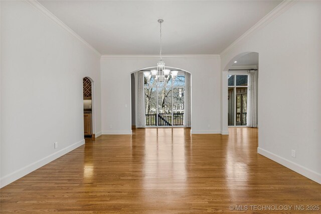 11630 S Fulton Ave, Tulsa, OK 74137 - unfurnished dining area with a chandelier, arched walkways, light wood-type flooring, ornamental molding, and baseboards