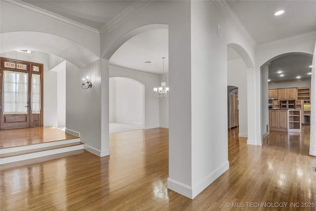 11630 S Fulton Ave, Tulsa, OK 74137 - entryway with light wood-style flooring, arched walkways, baseboards, and crown molding