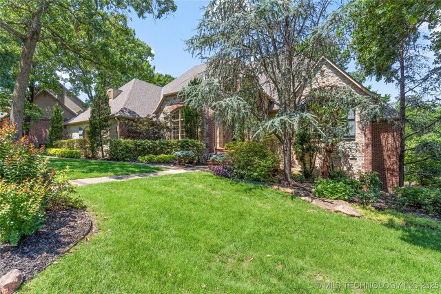 11630 S Fulton Ave, Tulsa, OK 74137 - view of front of house with brick siding and a front lawn