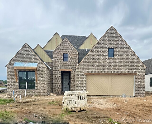 687 E 148th Pl S, Glenpool, OK 74033 - view of front facade with board and batten siding, brick siding, roof with shingles, and an attached garage