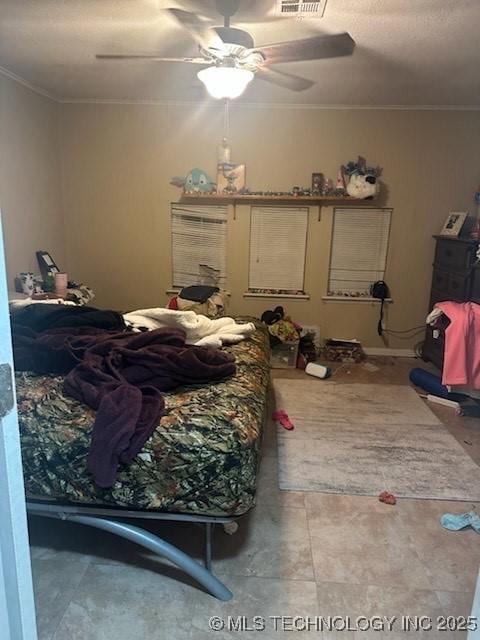 bedroom with ornamental molding, visible vents, and a ceiling fan