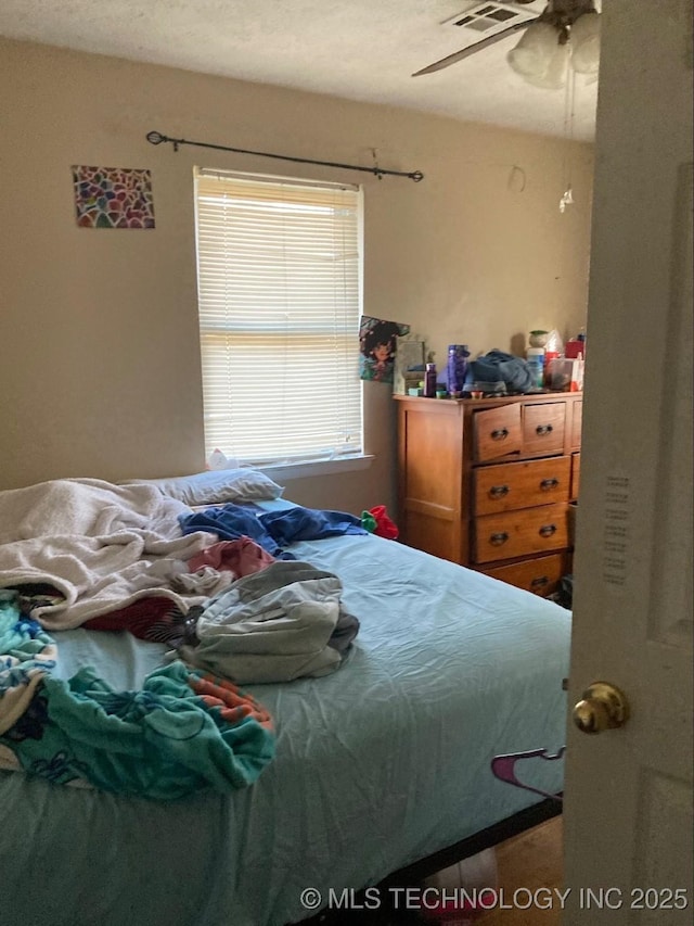 bedroom featuring visible vents and a ceiling fan