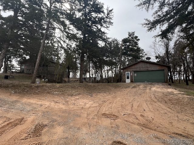 view of yard with dirt driveway and an outdoor structure