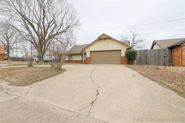 ranch-style house with a garage, concrete driveway, brick siding, and fence