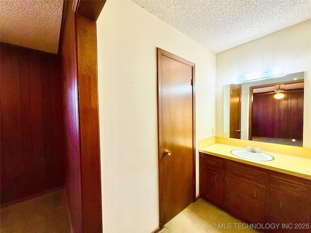 bathroom featuring a textured ceiling and vanity