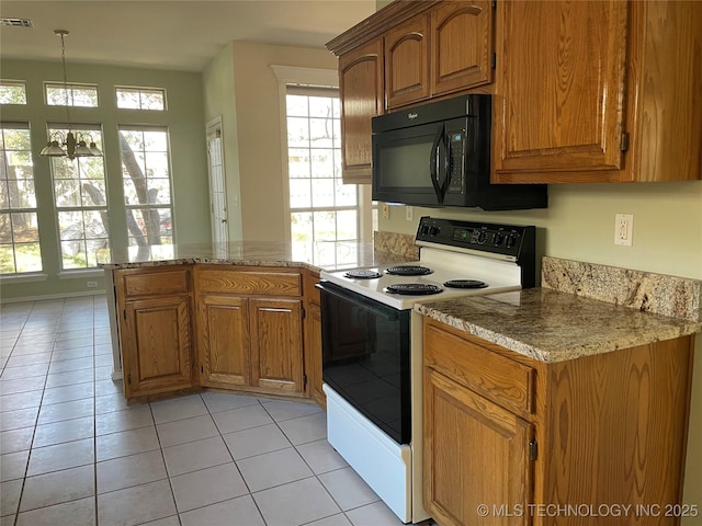 kitchen with white range with electric cooktop, visible vents, brown cabinetry, black microwave, and a peninsula