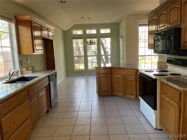 kitchen featuring light tile patterned floors, a peninsula, light stone countertops, black appliances, and a sink