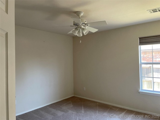 unfurnished room featuring visible vents, carpet, a wealth of natural light, and baseboards