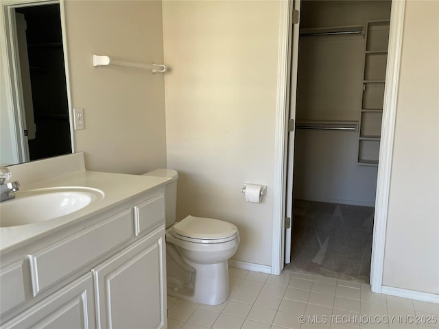 bathroom featuring tile patterned flooring, vanity, toilet, and baseboards