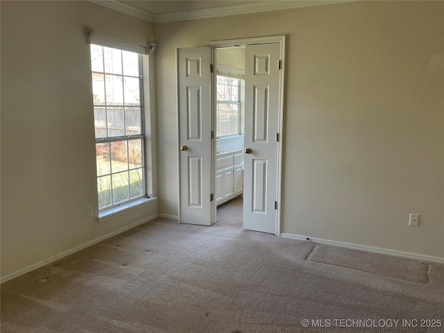 spare room featuring baseboards, carpet floors, and a healthy amount of sunlight