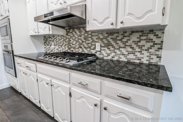 kitchen with appliances with stainless steel finishes, white cabinetry, and under cabinet range hood