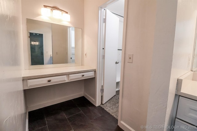 bathroom featuring vanity and baseboards