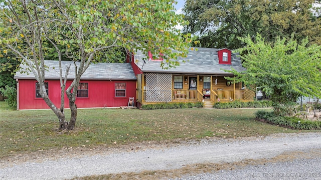 view of front of house with a porch and a front yard