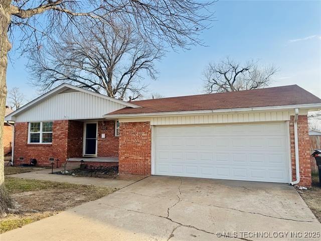 single story home featuring crawl space, brick siding, driveway, and an attached garage