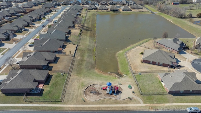 drone / aerial view featuring a residential view and a water view