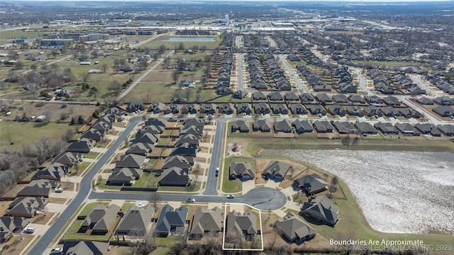 birds eye view of property featuring a residential view and a water view