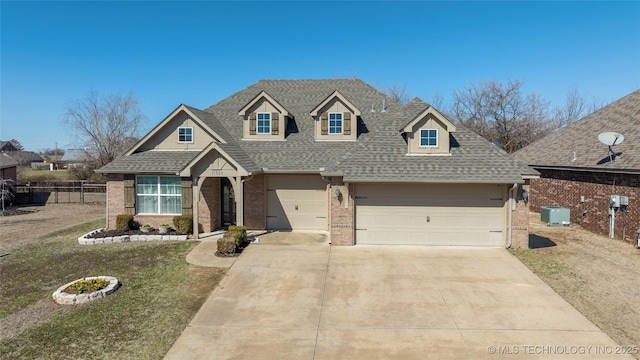 view of front of home with fence, roof with shingles, concrete driveway, central air condition unit, and brick siding