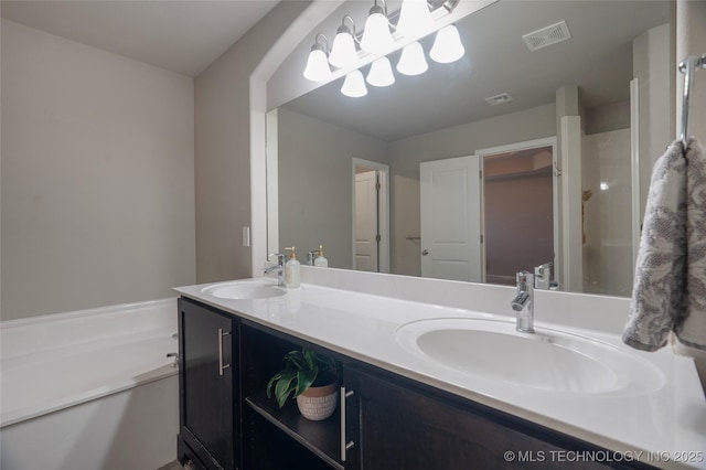 bathroom featuring double vanity, visible vents, and a sink