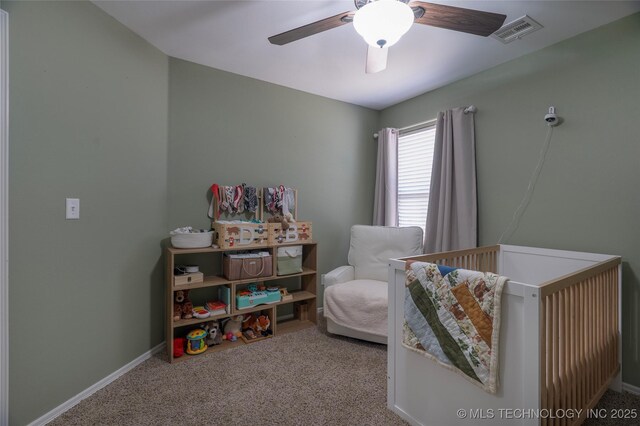 11923 E 105th Ct N, Owasso, OK 74055 - carpeted bedroom with baseboards, visible vents, a crib, and a ceiling fan
