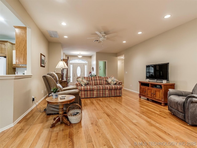 living room featuring recessed lighting, visible vents, light wood-style flooring, and baseboards