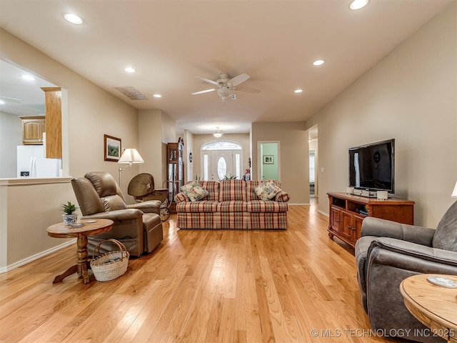 living area with recessed lighting, visible vents, light wood-style flooring, a ceiling fan, and baseboards