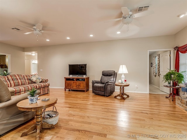 living room with a ceiling fan, recessed lighting, visible vents, and light wood-style flooring