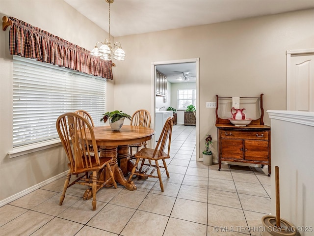 dining space featuring baseboards, light tile patterned flooring, and a notable chandelier