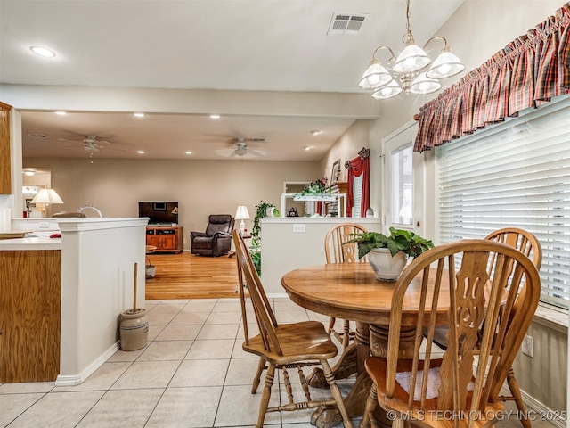 dining space with light tile patterned floors, recessed lighting, visible vents, and ceiling fan with notable chandelier