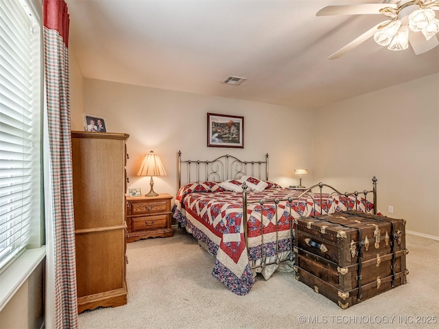 bedroom featuring visible vents, ceiling fan, and carpet flooring