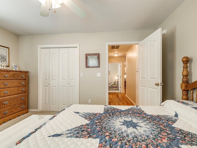 bedroom featuring attic access, a closet, visible vents, and a ceiling fan